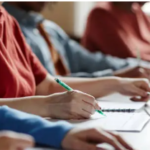 Students writing in a classroom environment to introduce the subtopic, "Develop Writing Skills Progressively".
