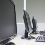 Picture of a row of computers in a lab to introduce the subtopic, "Utilize Technology Effectively".