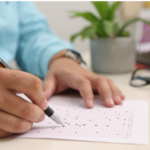 Picture of person taking a scantron test to introduce the subtopic, "Implement Regular Progress Monitoring".