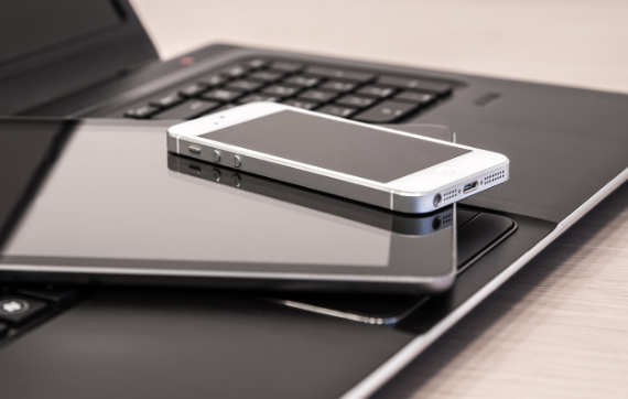 Smart phone, an iPad, and a laptop to show technology usage in the classroom.